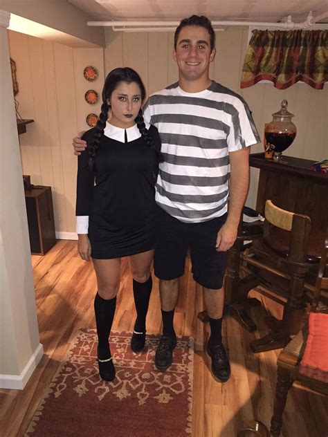 the man and woman are dressed up in costumes for halloween time, posing for a photo