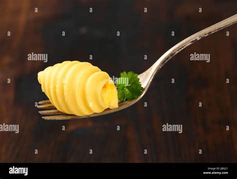 Butter curl on metal fork Stock Photo - Alamy