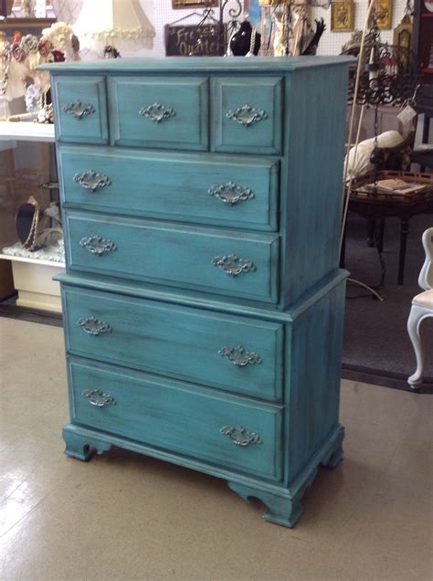 a blue dresser sitting on top of a store floor