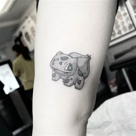 Bulbasaur tattoo located on the inner arm.