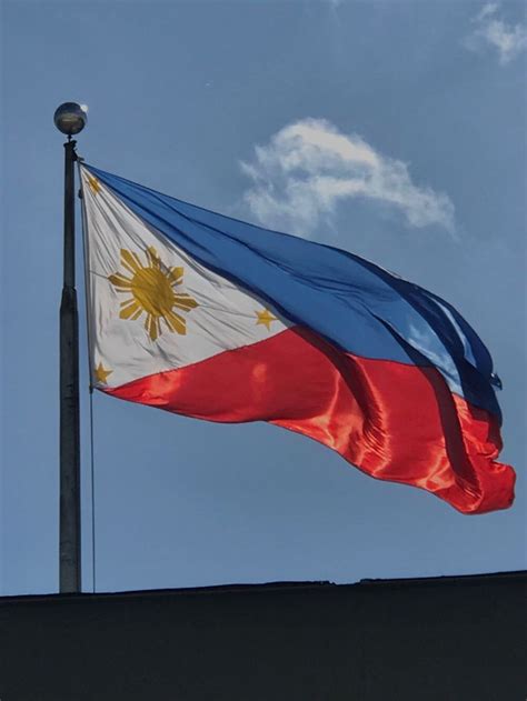 the philippines flag is flying high in the sky