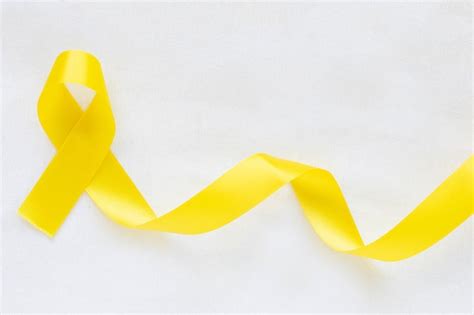 Premium Photo | Yellow ribbon. bone cancer, sarcoma awareness ...