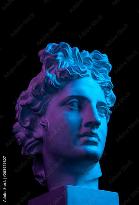 Gypsum copy of ancient statue Apollo head isolated on black background ...