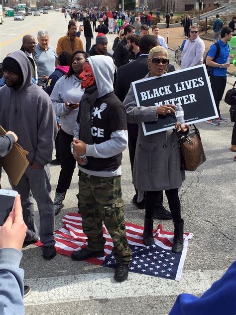 Black Lives Matter Stand on American Flag at Trump Protest : pics