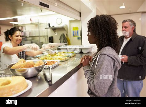 Kitchen Serving Food In Homeless Shelter Stock Photo - Alamy