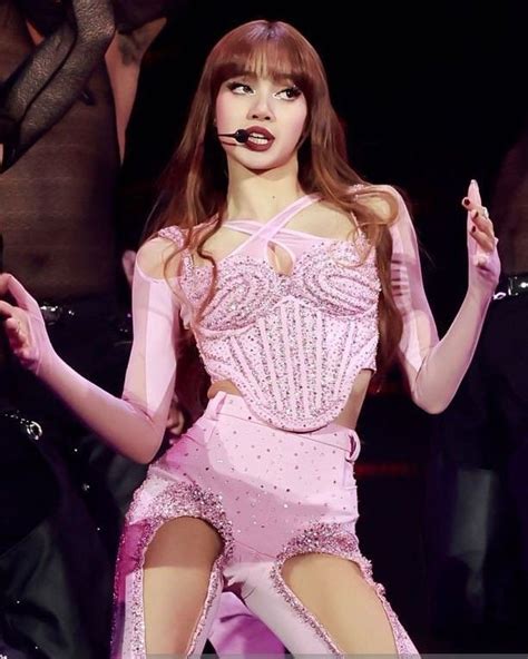 a woman in a pink dress on stage