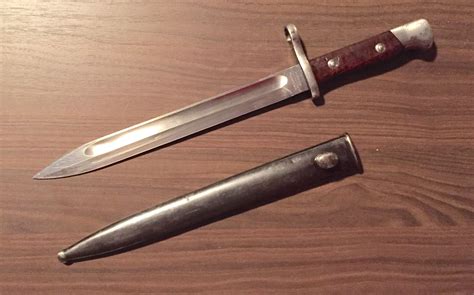 two knives sitting on top of a wooden table next to each other with one knife in the middle