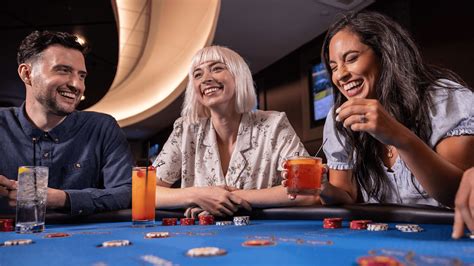 A group of friends drinking and playing blackjack.