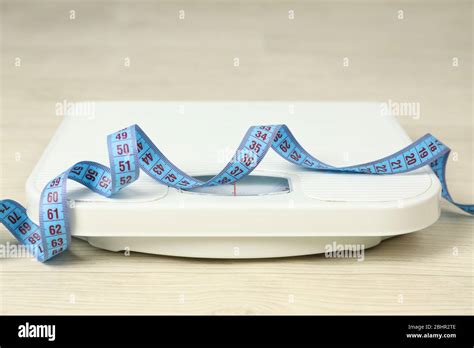 Scales and measuring tape. Weight loss concept Stock Photo - Alamy