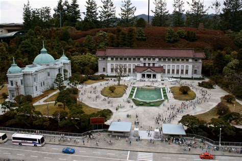 an aerial view of a large building with many people around it