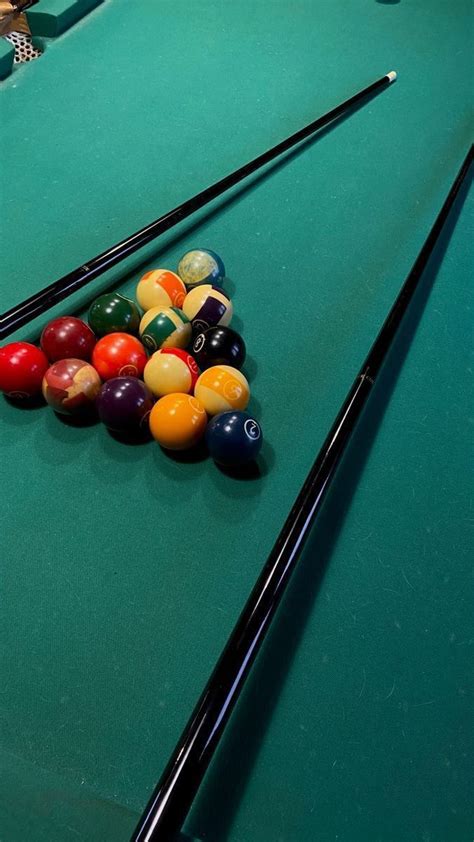 billiards and pool balls on a green table