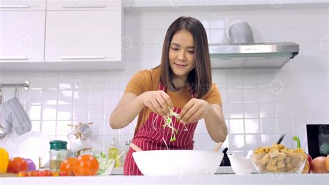 Young Asian woman cooking in kitchen at home. 11275780 Stock Photo at ...