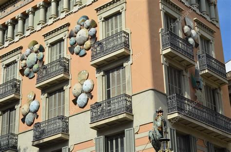 Architecture in La Rambla Street, building with umbrellas on walls in ...