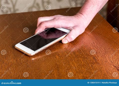 Hand Picking Up Mobile Phone from Table. Stock Image - Image of screen ...