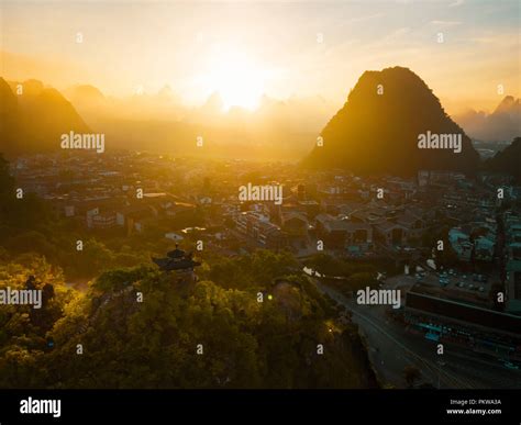 Aerial photo of a sunrise above the mountains and the city of Guangxi China Stock Photo - Alamy