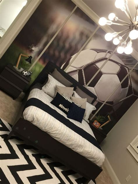 a bedroom with a soccer theme on the wall