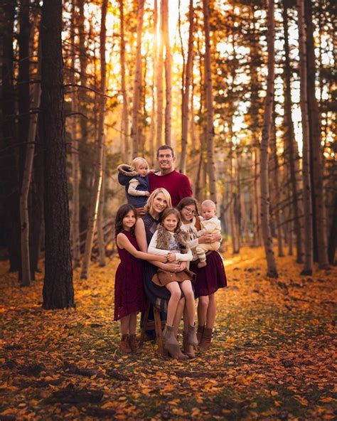 a family posing for a photo in the woods