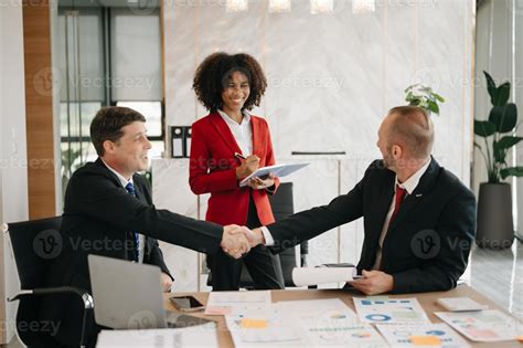 business people shaking hands during a meeting in modern office ...