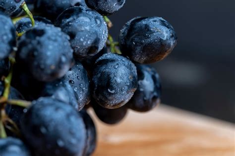 Premium Photo | Fresh wet grapes of blue color cooking using sweet ...