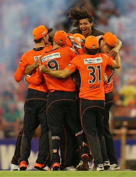 A spectator joins the Perth Scorchers players after their win ...