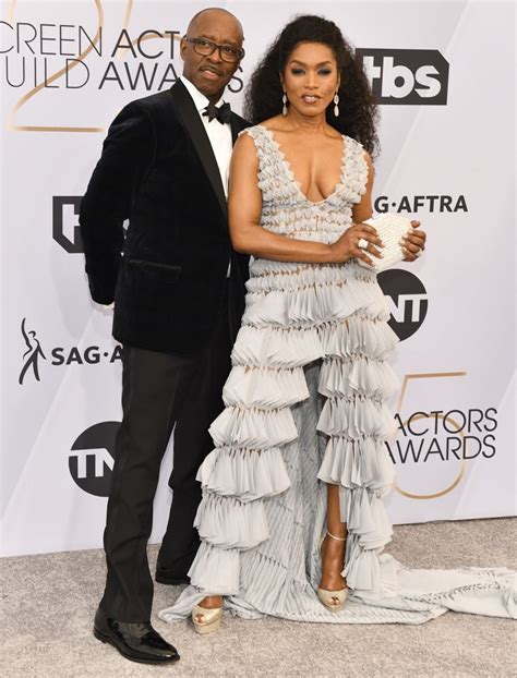 Angela Bassett defies her 60 years in plunging dress with high slit in pics with husband of 21 yrs