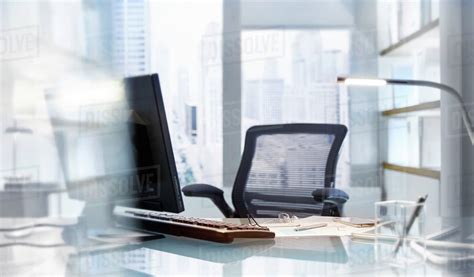 Empty desk in modern office - Stock Photo - Dissolve