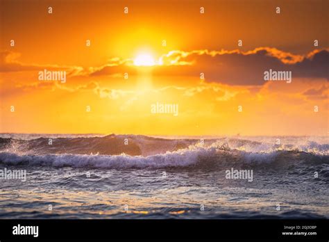 Beautiful sunrise wave Stock Photo - Alamy