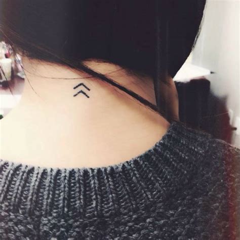 Back of the neck tattoo of two Kenaz runes on Victoria,