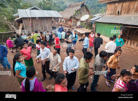 Robert Hahn, Mung, and other partygoers dance in traditional Lao style ...