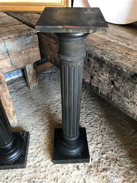 A pair of black wooden pedestal column display stands - Belle and Beast Emporium