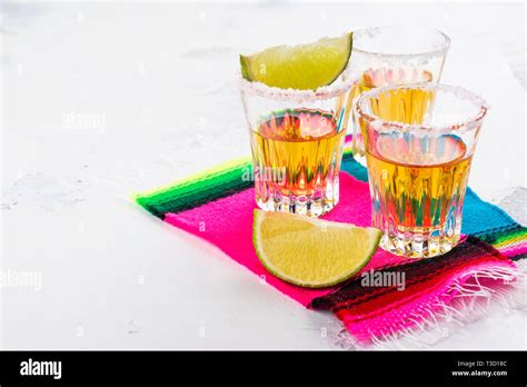 Mexican golden tequila shots Stock Photo - Alamy