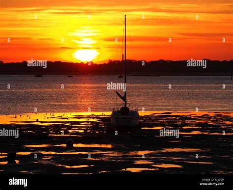 Sunset over Portsmouth harbour, Hampshire, England. As seen from the shoreline of Whale island ...