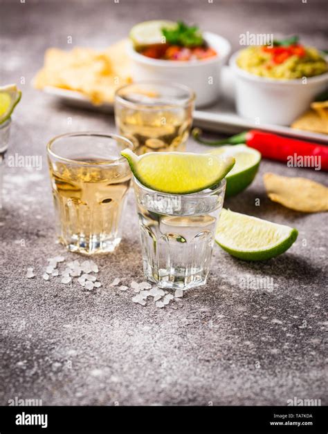 Shots of silver and gold tequila Stock Photo - Alamy