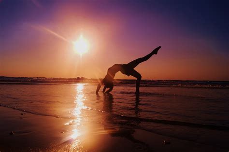 Sunset Serenity: Woman Practicing Yoga - 4K Ultra HD Wallpaper