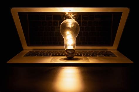 Premium Photo | Light bulb with laptop