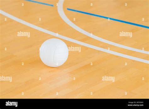 Volleyball with white color on Wooden Court Stock Photo - Alamy