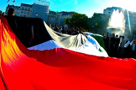 Palestine Protest in London. A giant flag covers the ground in Trafalgar Square. The weather was ...