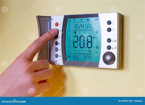 Closeup Of A Womans Hand Setting The Room Temperature On A Mode Stock Photo - Image: 50292768