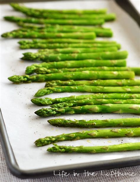 asparagus spears on a baking sheet ready to be cooked in the oven for dinner