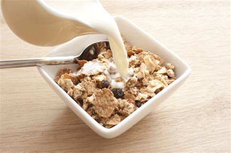 Pouring milk into cereal - Free Stock Image