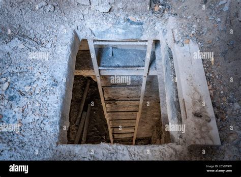 trapdoor in the floor with staircase in an abandoned factory, veneto ...