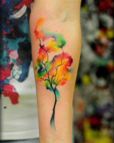 a colorful tree tattoo on the arm