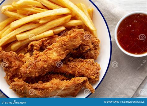 Crispy Chicken Strips with French Fries and Sour-Sweet Sauce Stock ...