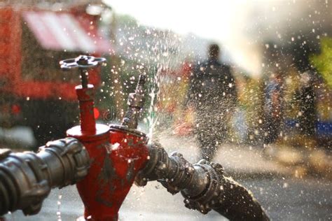 Water Splashes from the Fire Hose and Hydrant Connections. Firefighters Work Concept Stock Photo ...