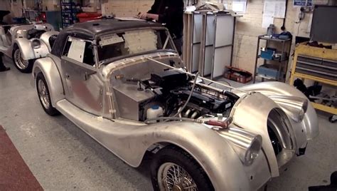 an old car is being worked on in a garage