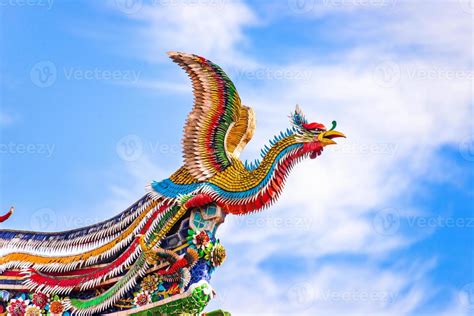 Beautiful Phoenix flying on the decorative tile roof in Chinese temples. Colorful roof detail of ...