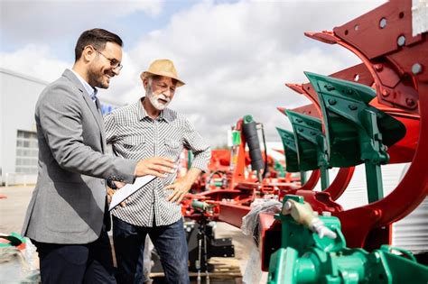 Premium Photo | Farmer buying new plow equipment for his tractor