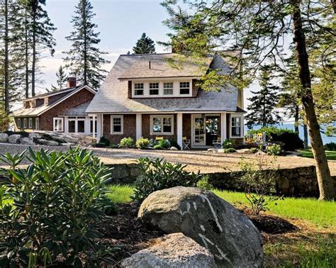 a large house sitting on top of a lush green field next to a tree ...