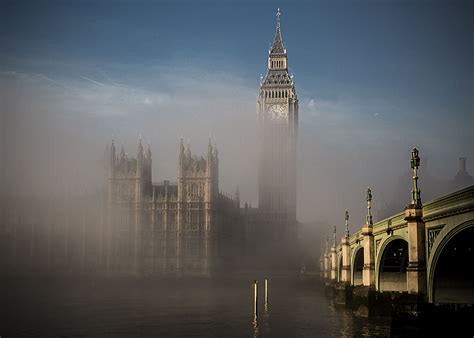 Mist shrouds Big Ben at the Palace of Westminster, as seen over the Thames.