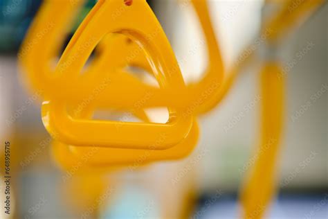 The interior of a modern bus with yellow railings for support during ...